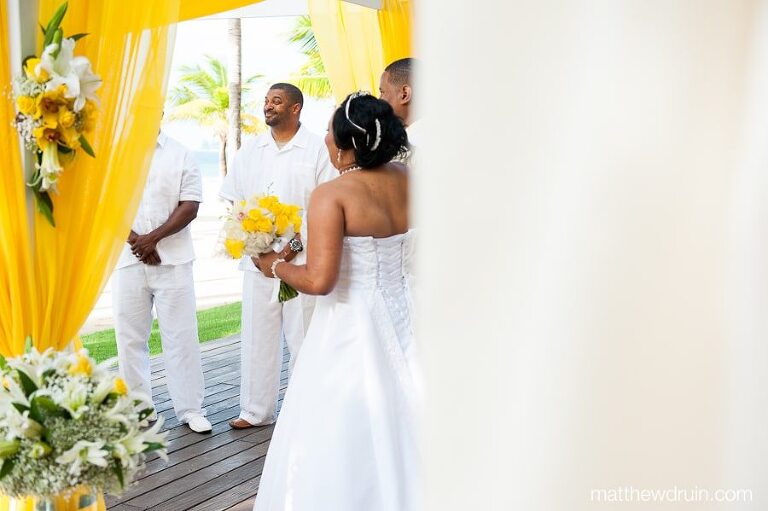 Bride and groom at altar with groomsmen in white linen suit at Puerto Rico wedding ceremony 
