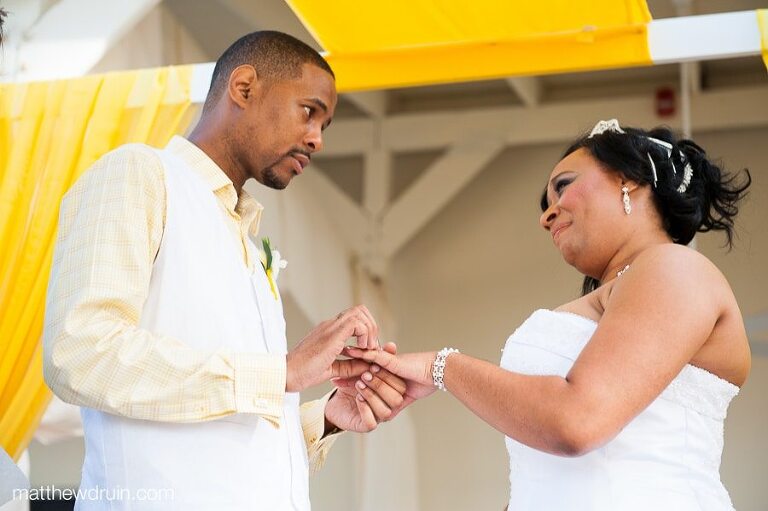 Bride crying while groom puts wedding ring on her finger at Puerto Rico wedding ceremony 