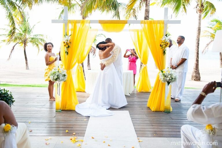Bride and groom first kissing at altar of beach wedding at Puerto Rico wedding ceremony 