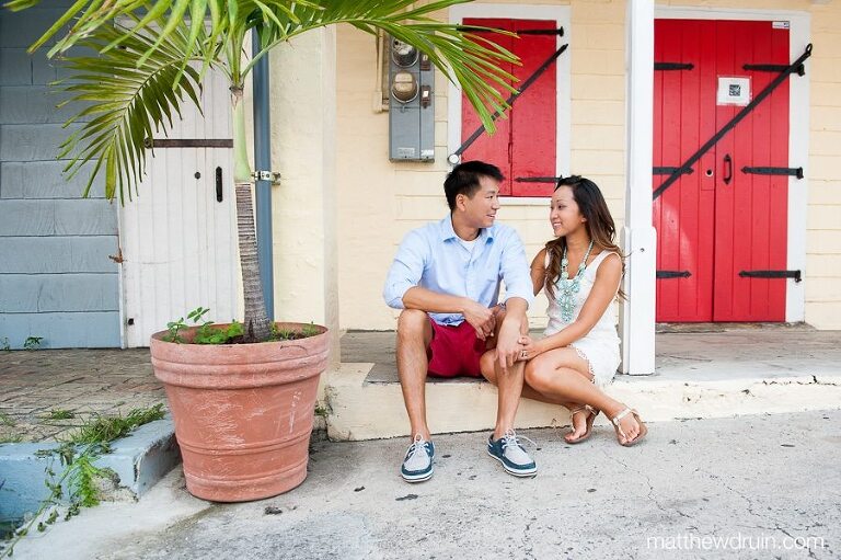 Engaged couple sitting on porch holding hands St. Croix Virgin Islands engagement session