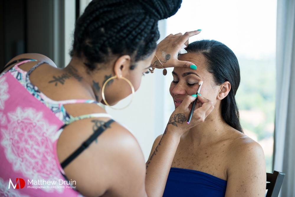 Makeup artist applying makeup to bridesmaid at The Peachtree Club wedding