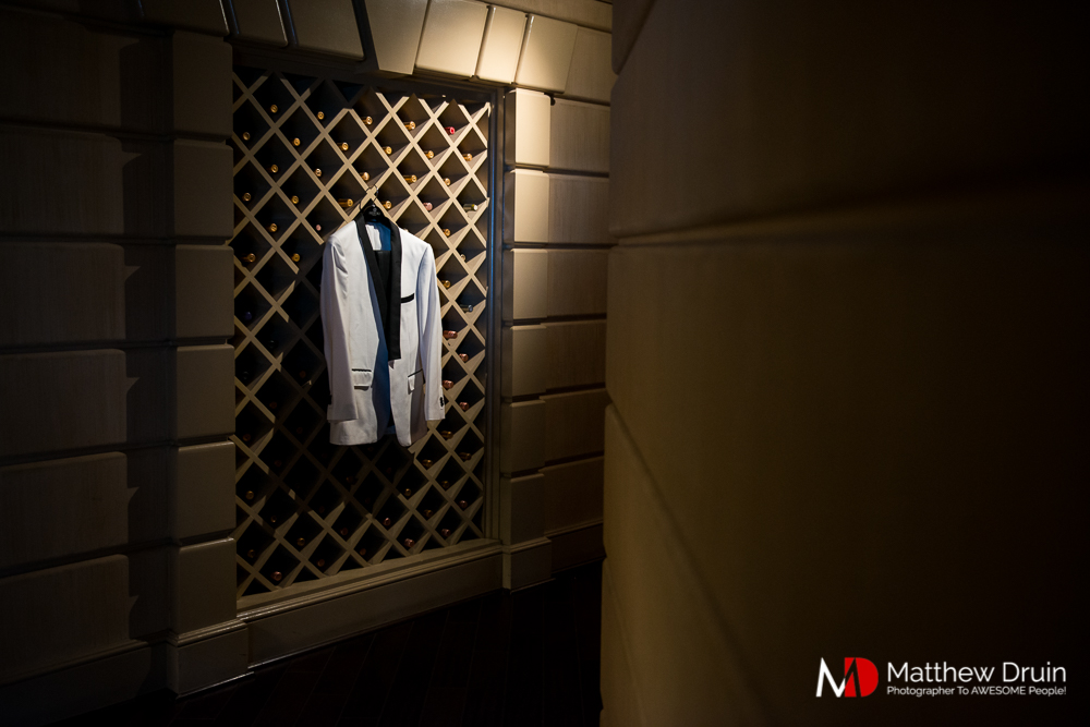 Groom's suite hanging on wine rack at The Peachtree Club wedding