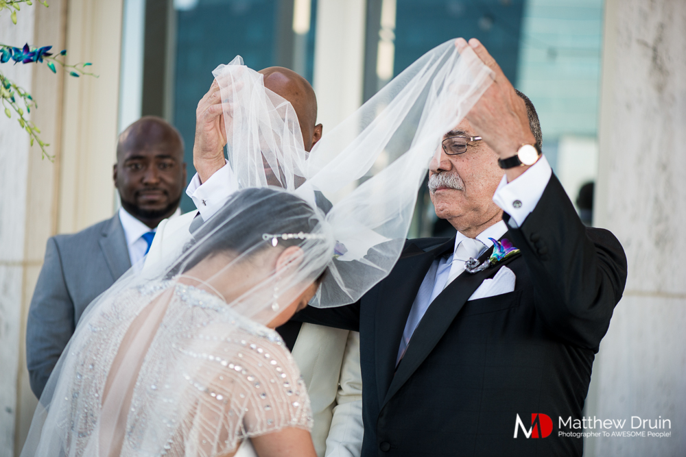 Bride's father lifting her veil at The Peachtree Club wedding ceremony