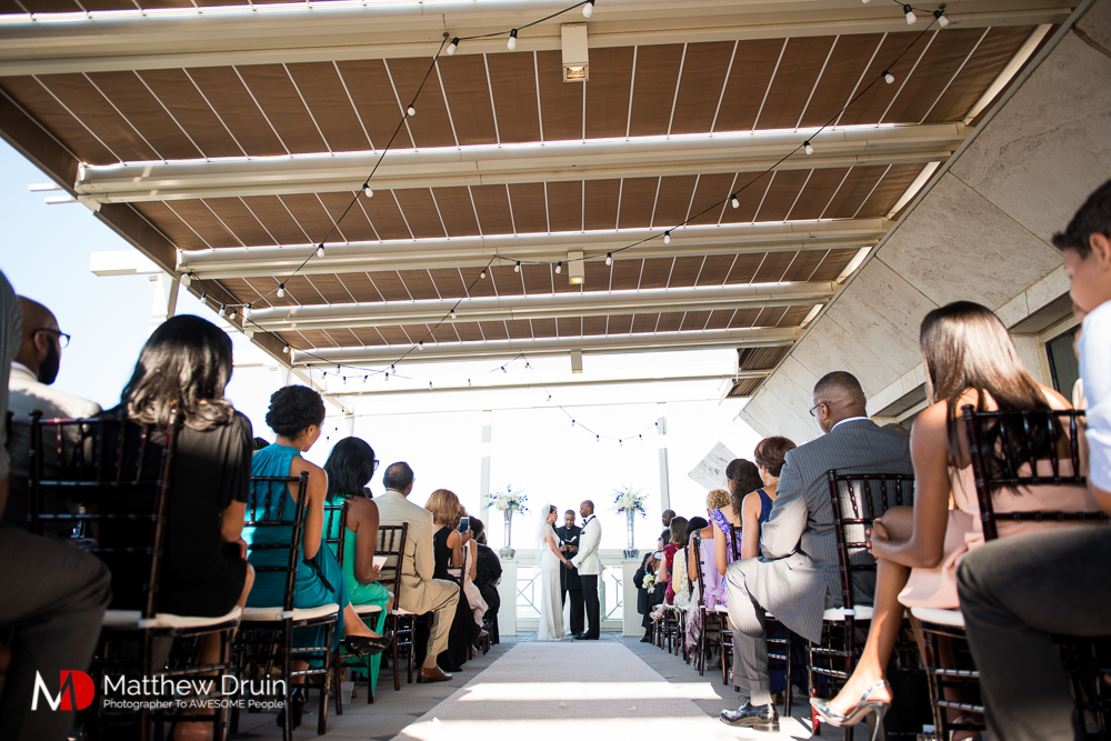 Bride and groom at alter on balcony at The Peachtree Club wedding ceremony