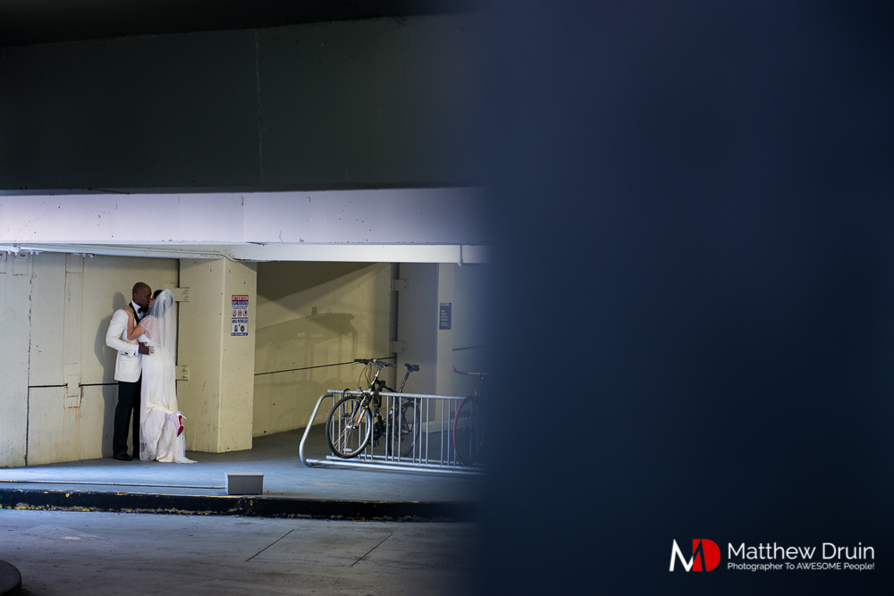 Bride and groom kissing in parking garage at The Peachtree Club wedding