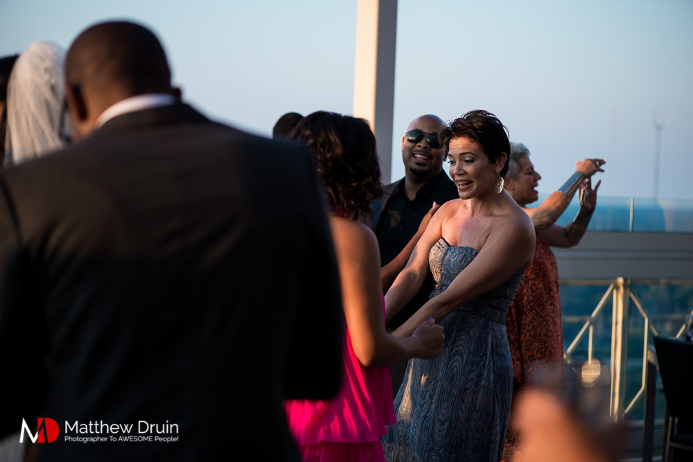 Wedding guests dancing at sunset at The Peachtree Club wedding reception