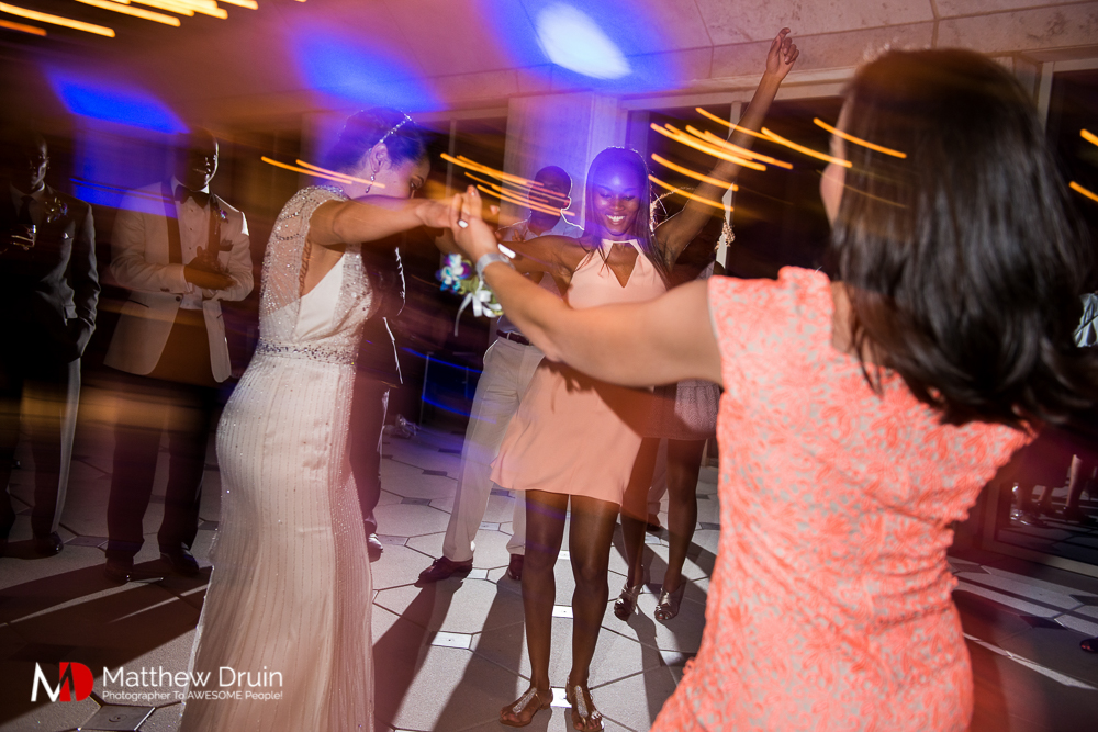 Bride dancing with wedding guests at The Peachtree Club wedding reception