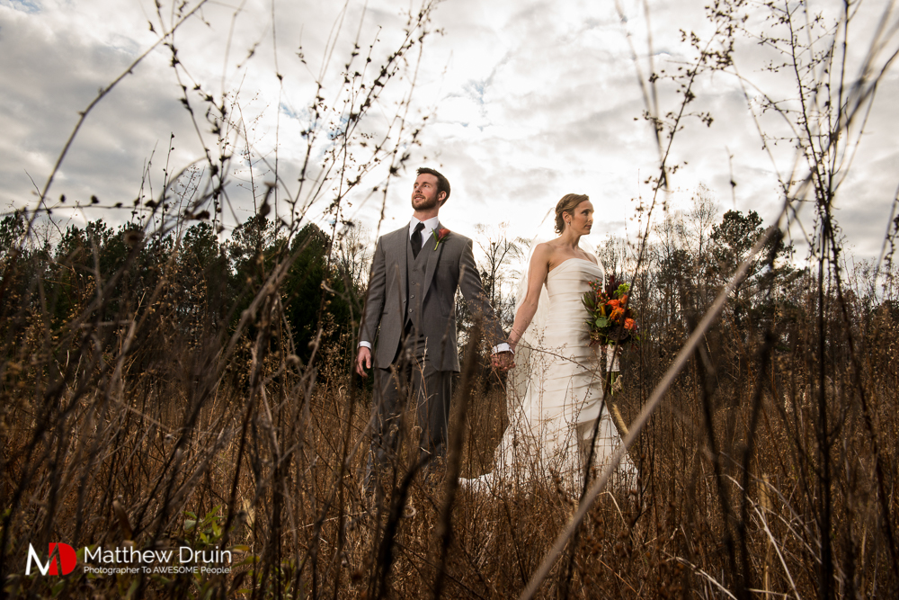 Bride and groom standing in field at sunset at Atlanta Wedding Venue Proctor Farm In Georgia Review