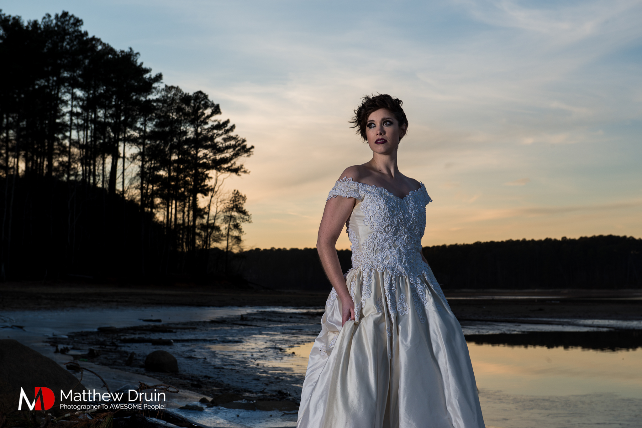 Bride standing in frozen lake in Atlanta at sunset