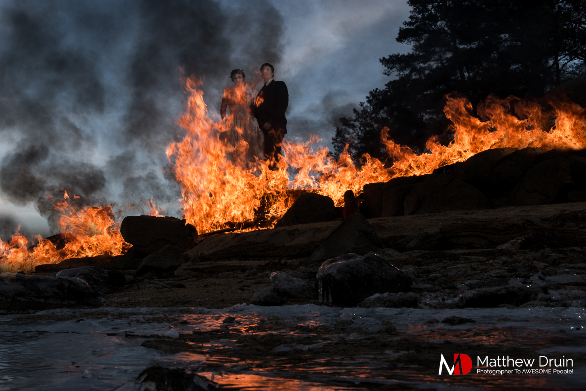 Photo of bride and groom on fire in frozen lake in Atlanta at sunset
