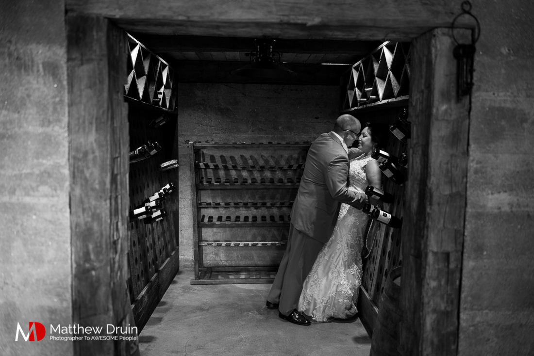 Bride and groom kissing in wine cellar at vintage wedding at The Cellar at Betty Creek from Atlanta Wedding Photographers Matthew Druin + Co Photography.