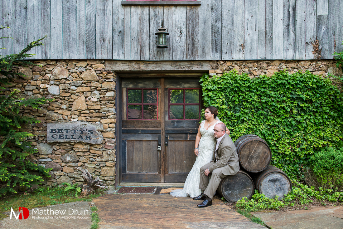 Bride and groom sitting outside wine cellar at vintage wedding at The Cellar at Betty Creek from Atlanta Wedding Photographers Matthew Druin + Co Photography.